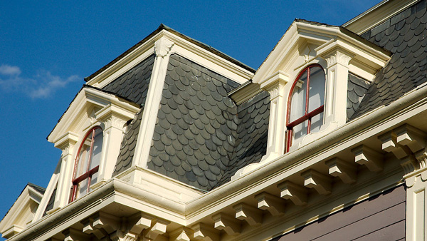 Victorian style home with a slated roof.